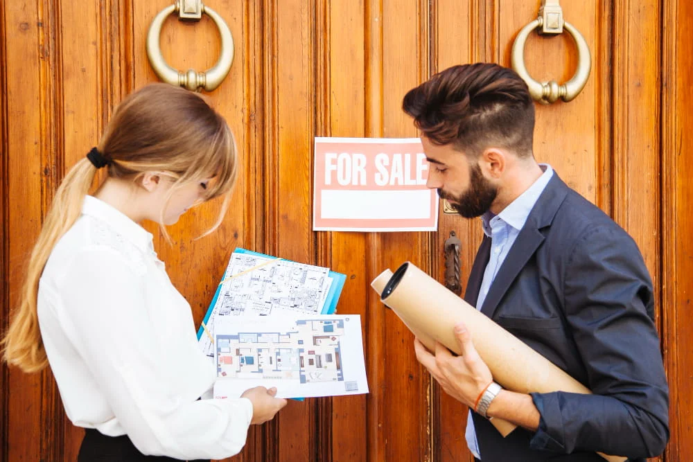 real-estate-agents-waiting-with-plans-front-door